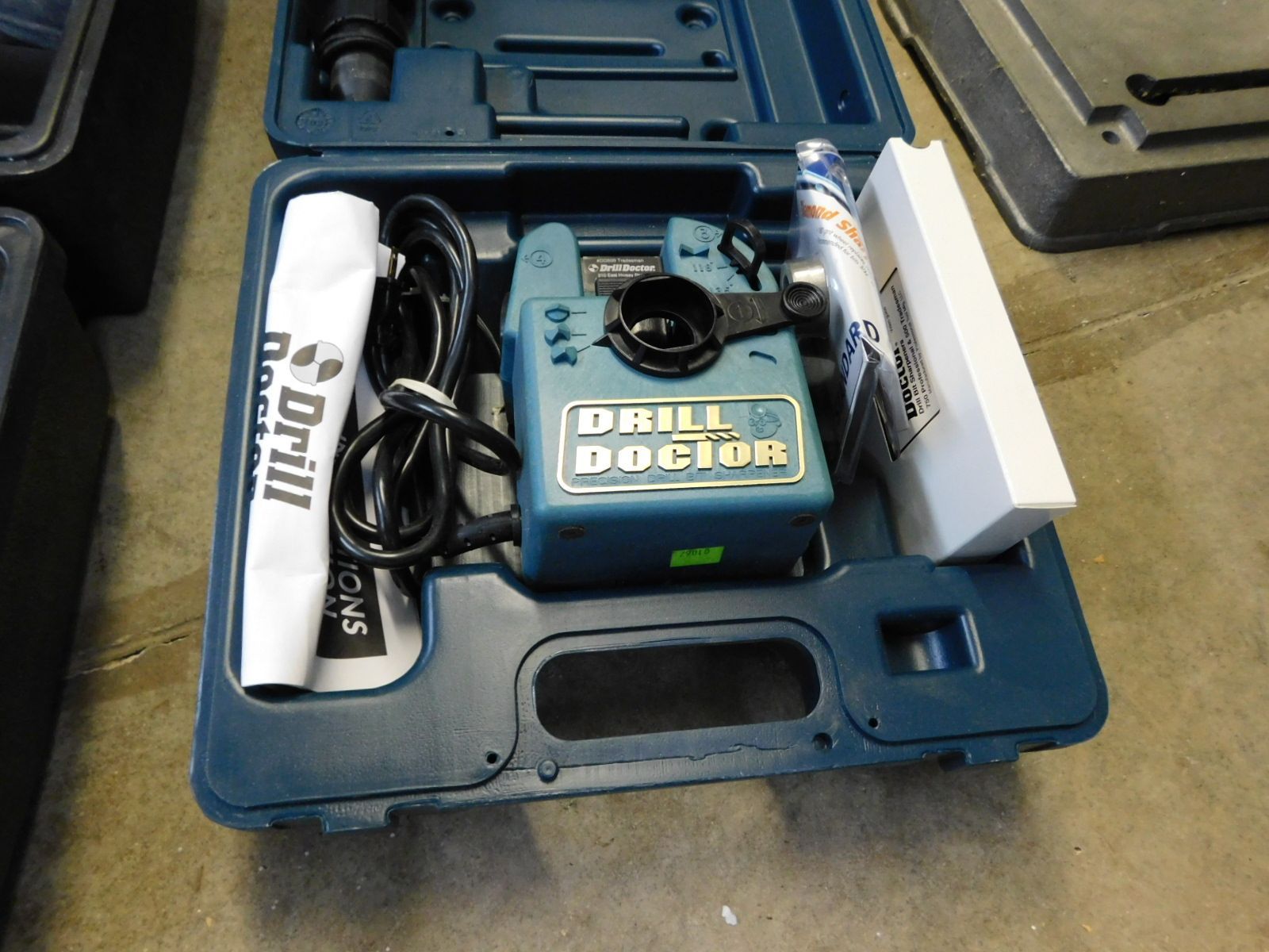 A drill doctor is sitting in a blue case