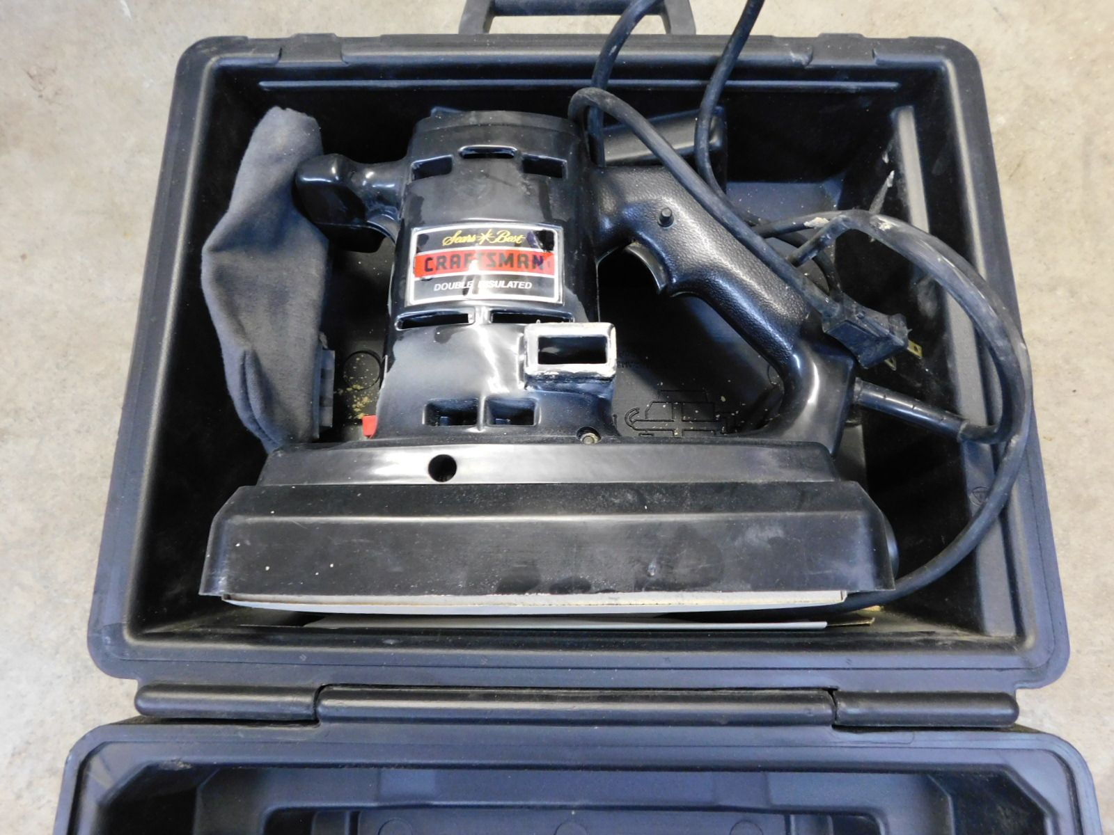 A black sander is sitting in a black case