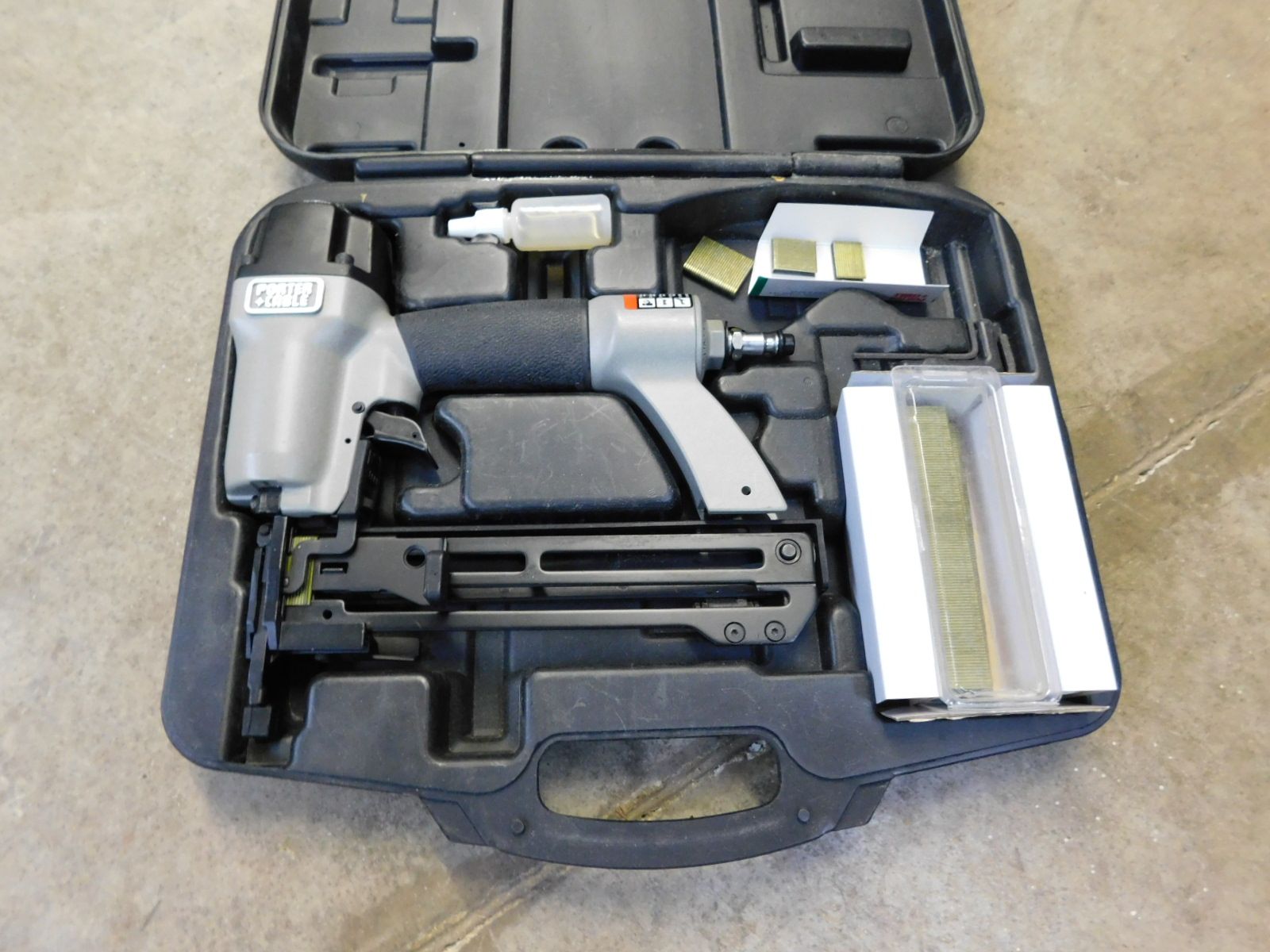 A black case with a stapler inside of it