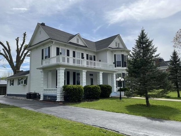 A house with two garage doors and a concrete driveway