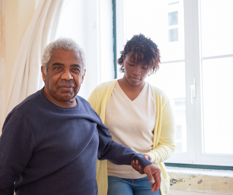 Friendly senior companion in Houston assisting an elderly woman with daily activities at home, offer