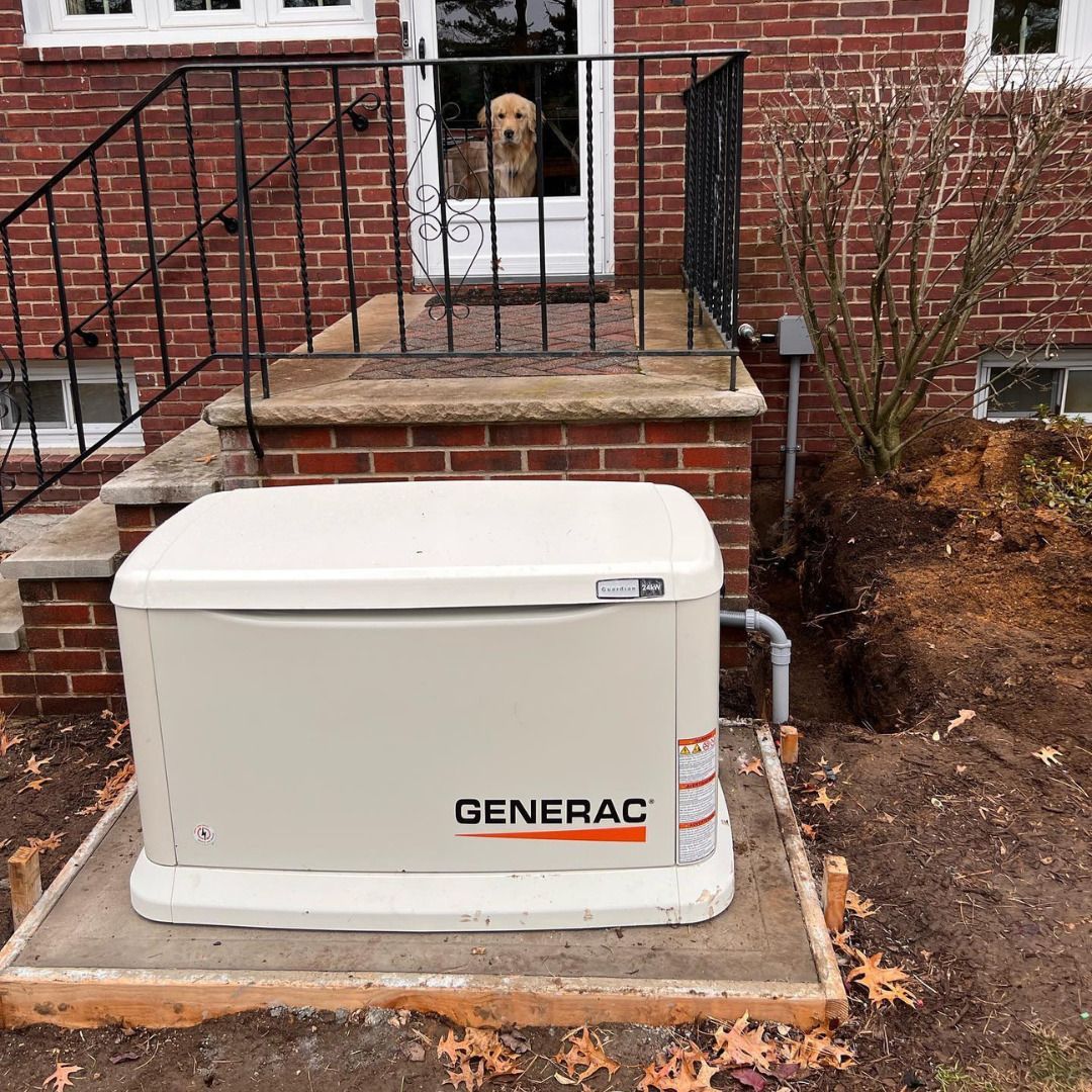 A Generac generator on a concrete pad in front of a brick house with a dog in the doorway.