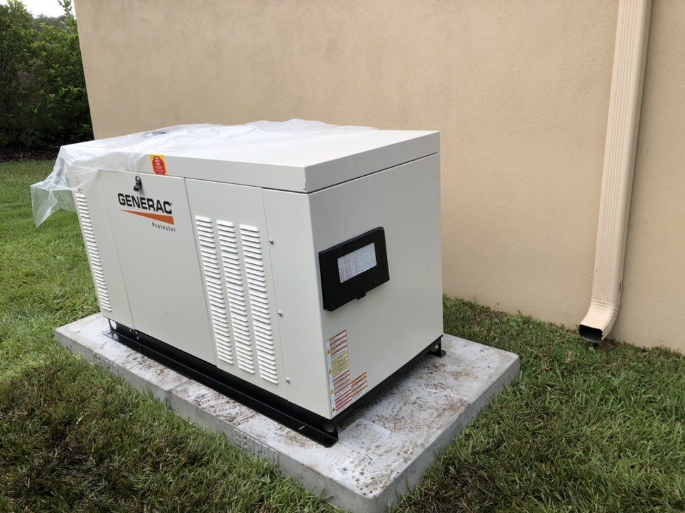 Beige Generac generator on concrete pad in a grassy yard, next to a beige wall.