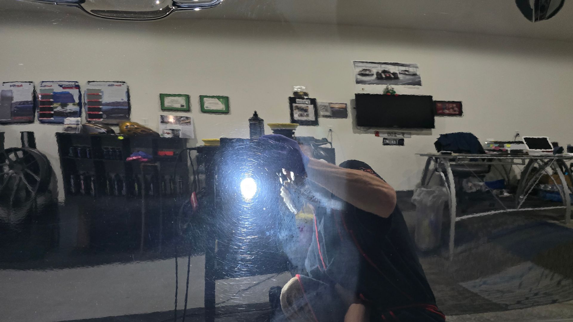 Man welding with a bright flash in a workshop.