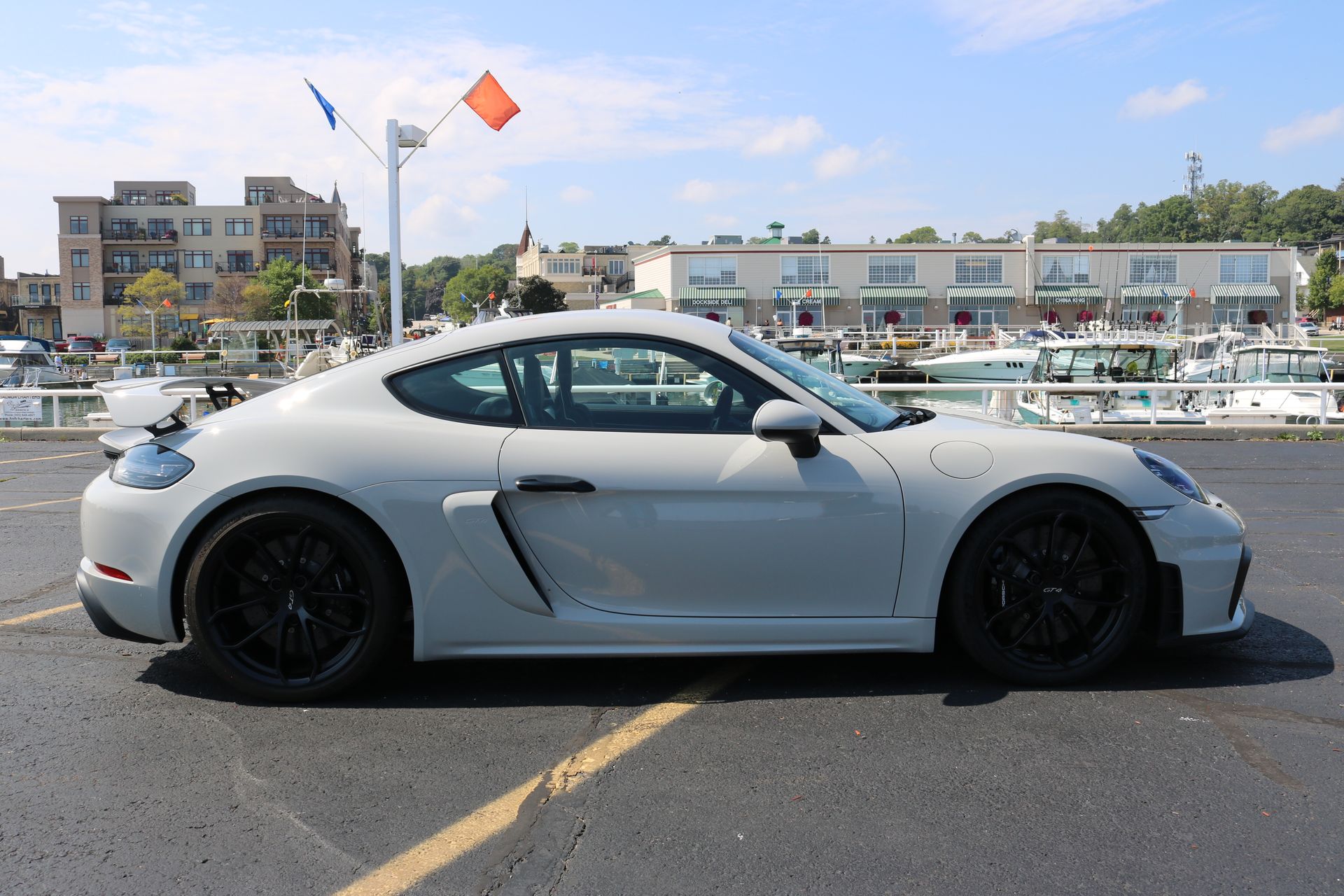 A white sports car is parked in a parking lot.