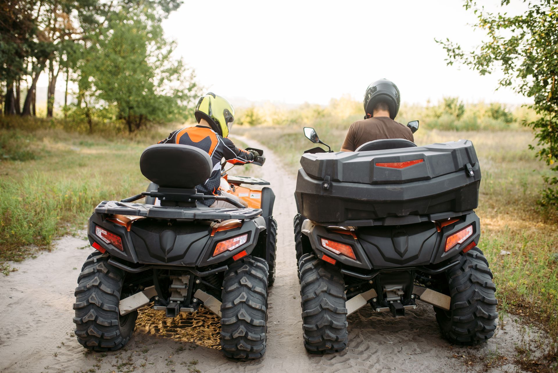 two atvs on a dirt road