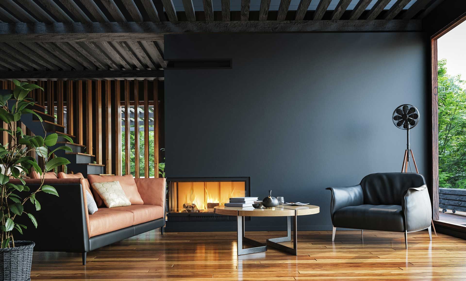 Modern living room with black sofa, fireplace, wooden armchairs, and floor-to-ceiling windows