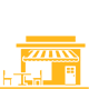 A yellow building with a awning and tables and chairs in front of it.