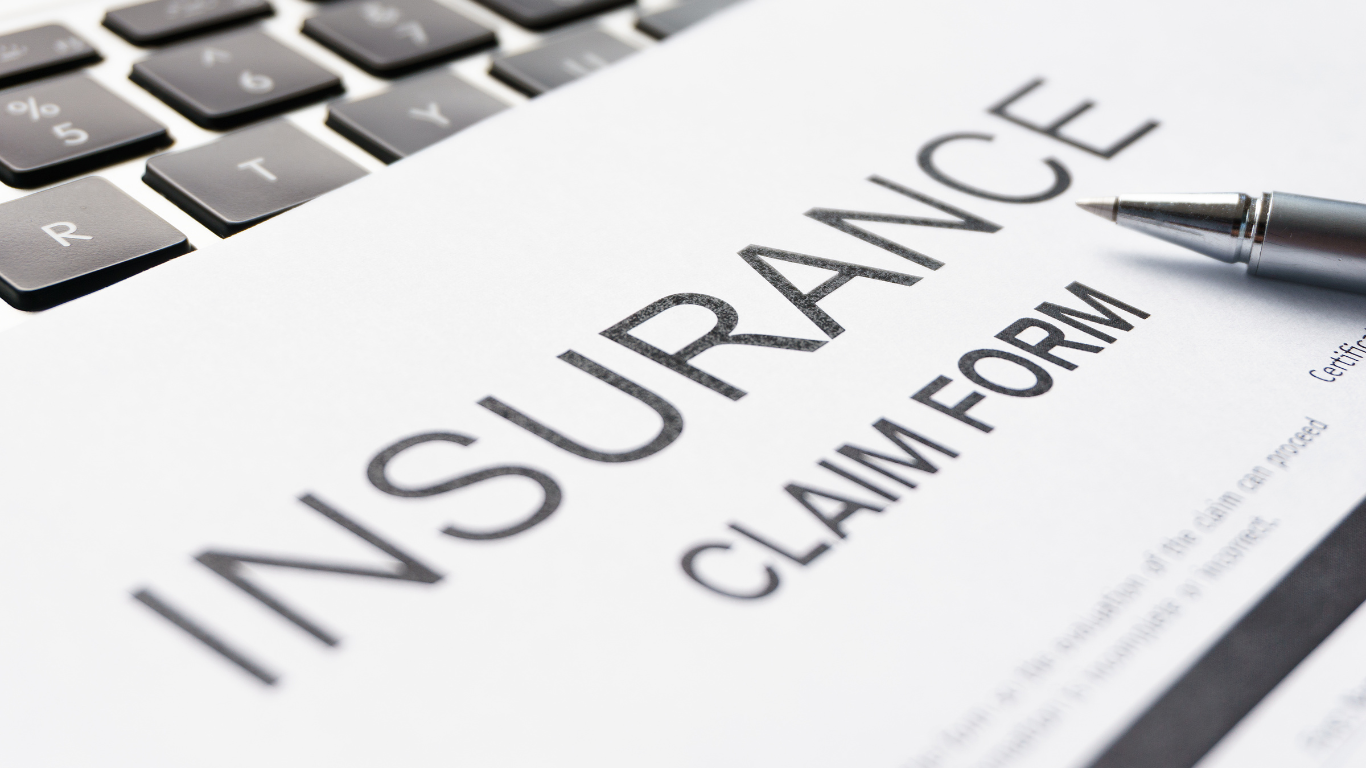 A pen is sitting on top of an insurance claim form.