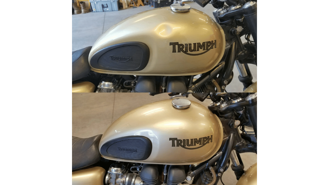 Two triumph motorcycles are parked next to each other in a garage.