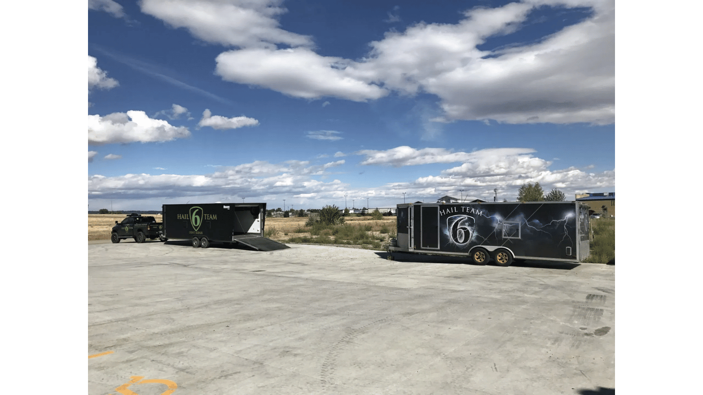 Two trucks are parked next to each other in a parking lot.