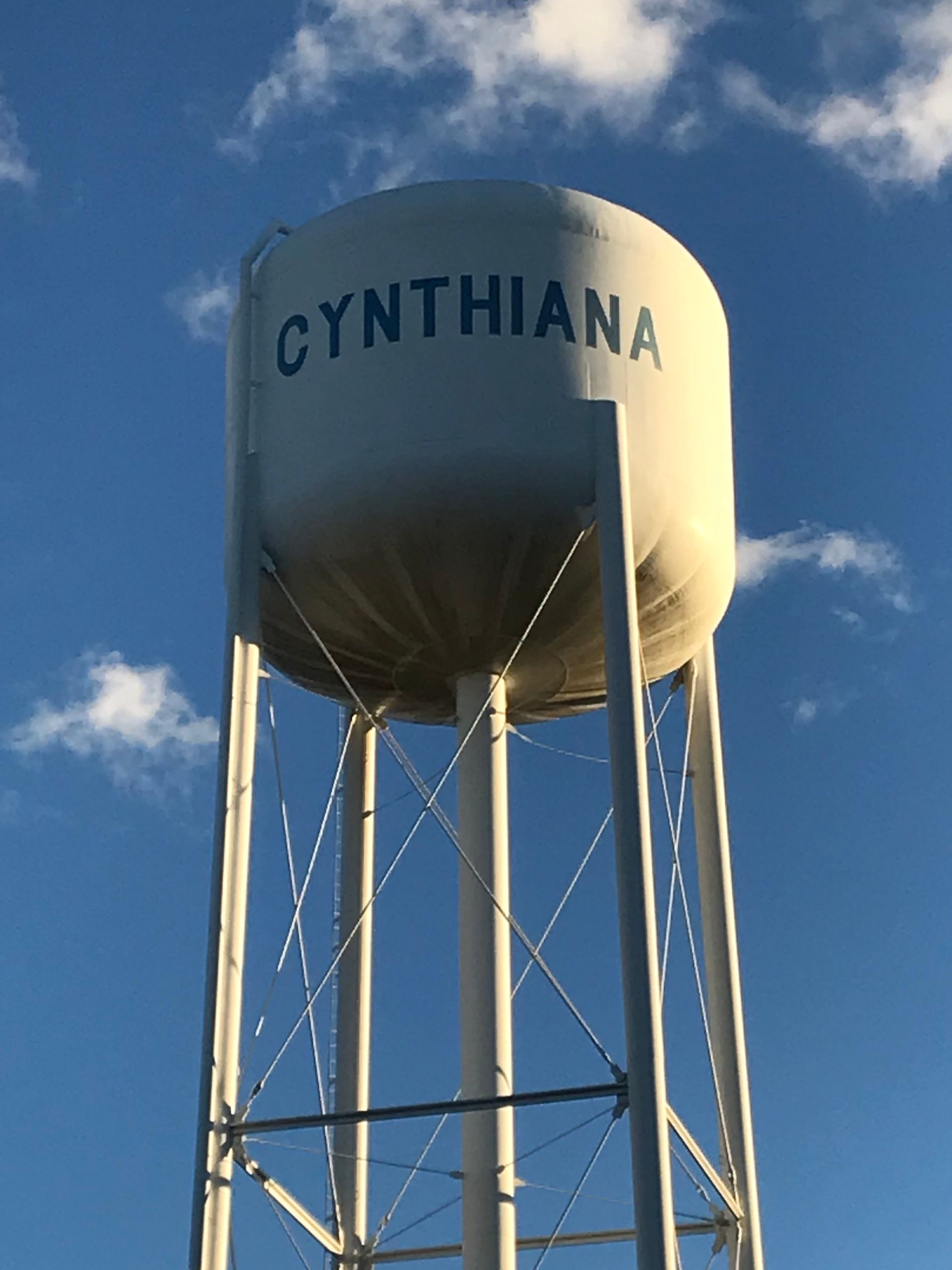 Cynthiana water tower against a blue sky with scattered clouds