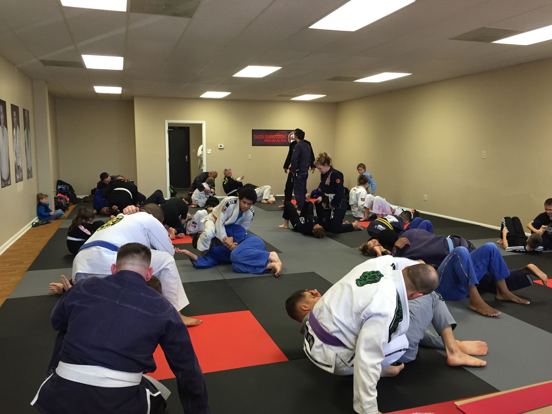Adults training Brazilian Jiu-Jitsu at Sugoi Submission in Corpus Christi, TX, building fitness.