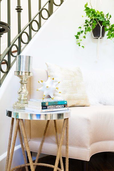 A living room with a couch and a table with books on it
