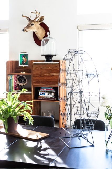 A room with a ferris wheel and a deer head on the wall