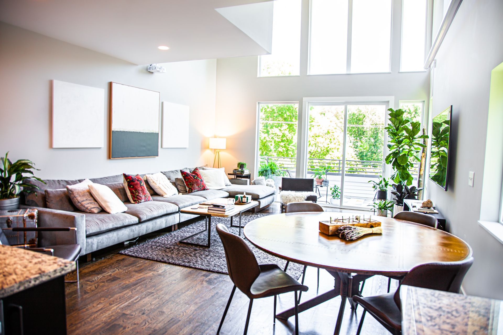 A living room with a couch , table and chairs.