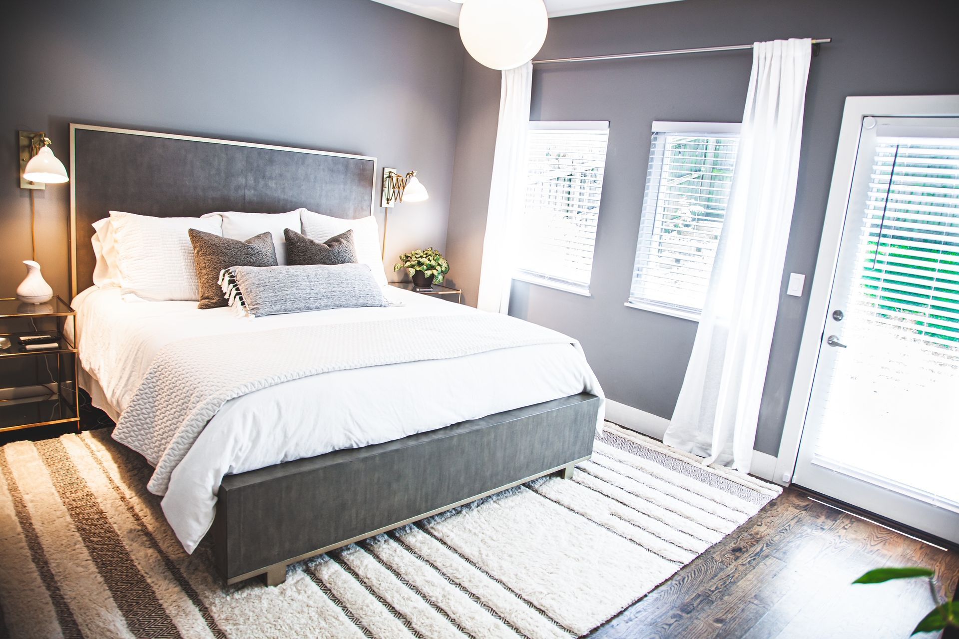 A bedroom with a bed , nightstands , and a rug.