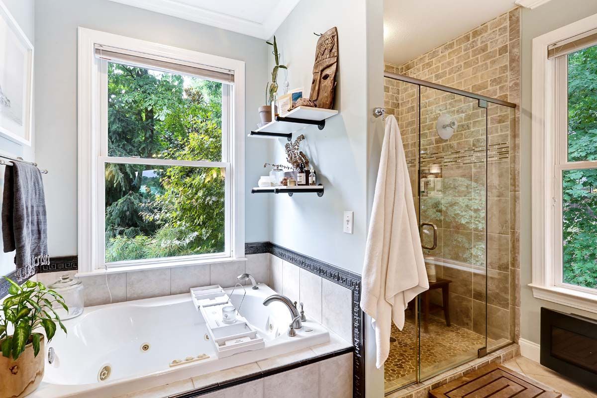 A bathroom with a jacuzzi tub and a walk in shower.
