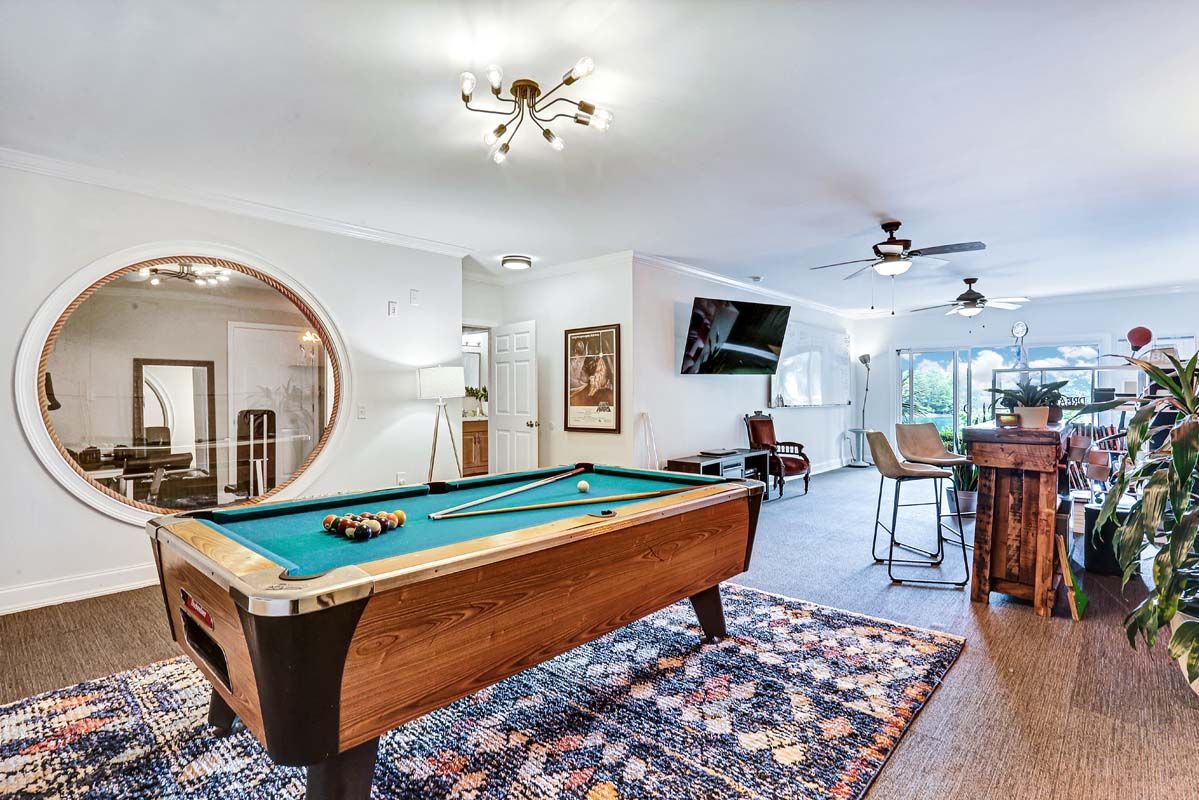 There is a pool table in the middle of the room.