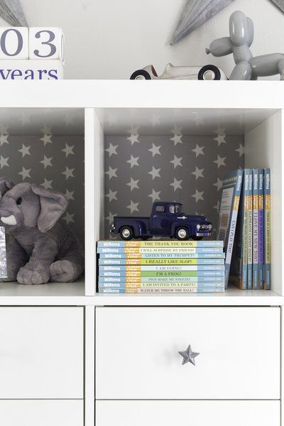 A shelf with a stuffed elephant and a truck on it