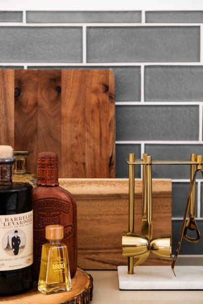 A bottle of whiskey is sitting on top of a wooden cutting board.