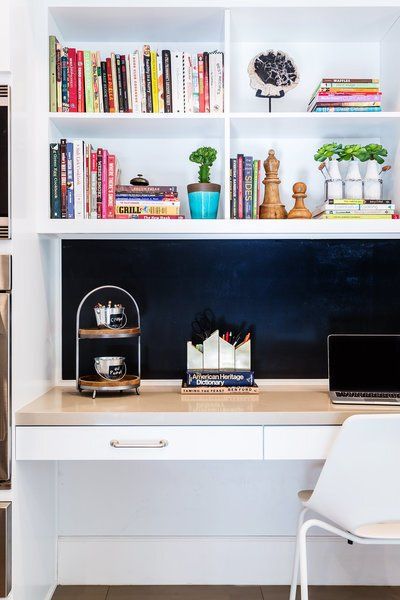 A kitchen with a desk and a laptop on it