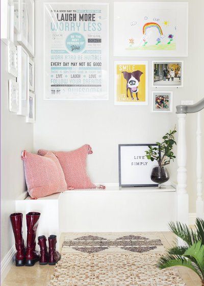 A corner of a room with a bench and a sign that says laugh more funny less