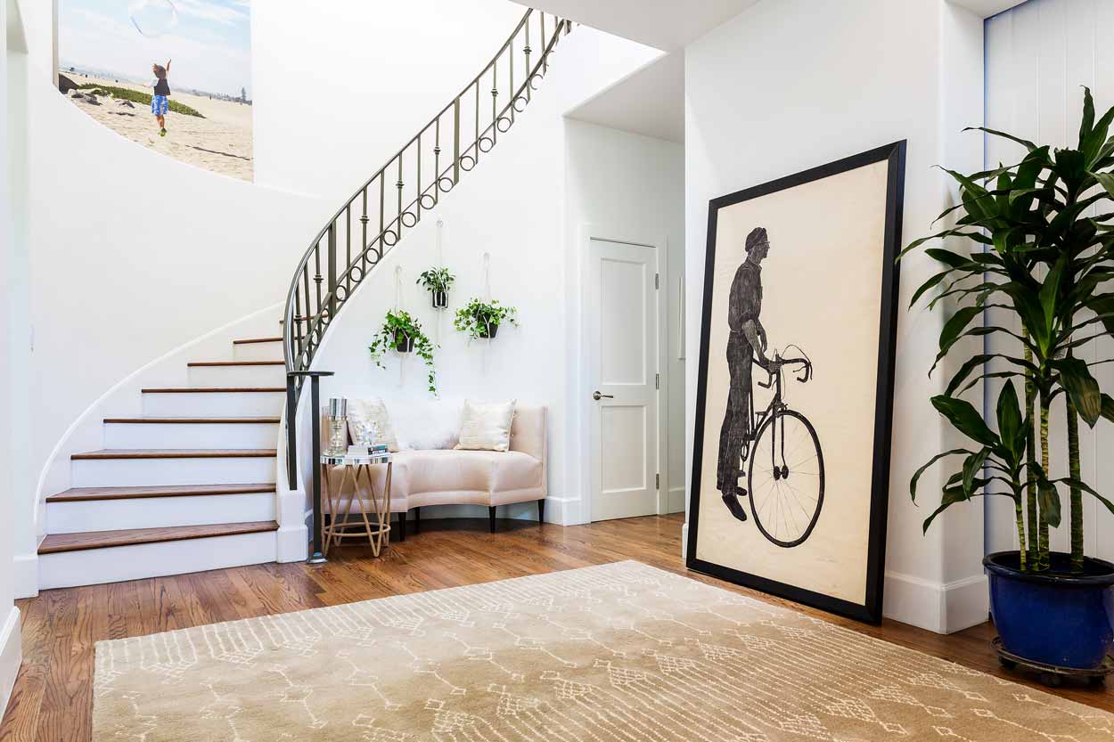 There is a picture of a man riding a bike in the hallway.