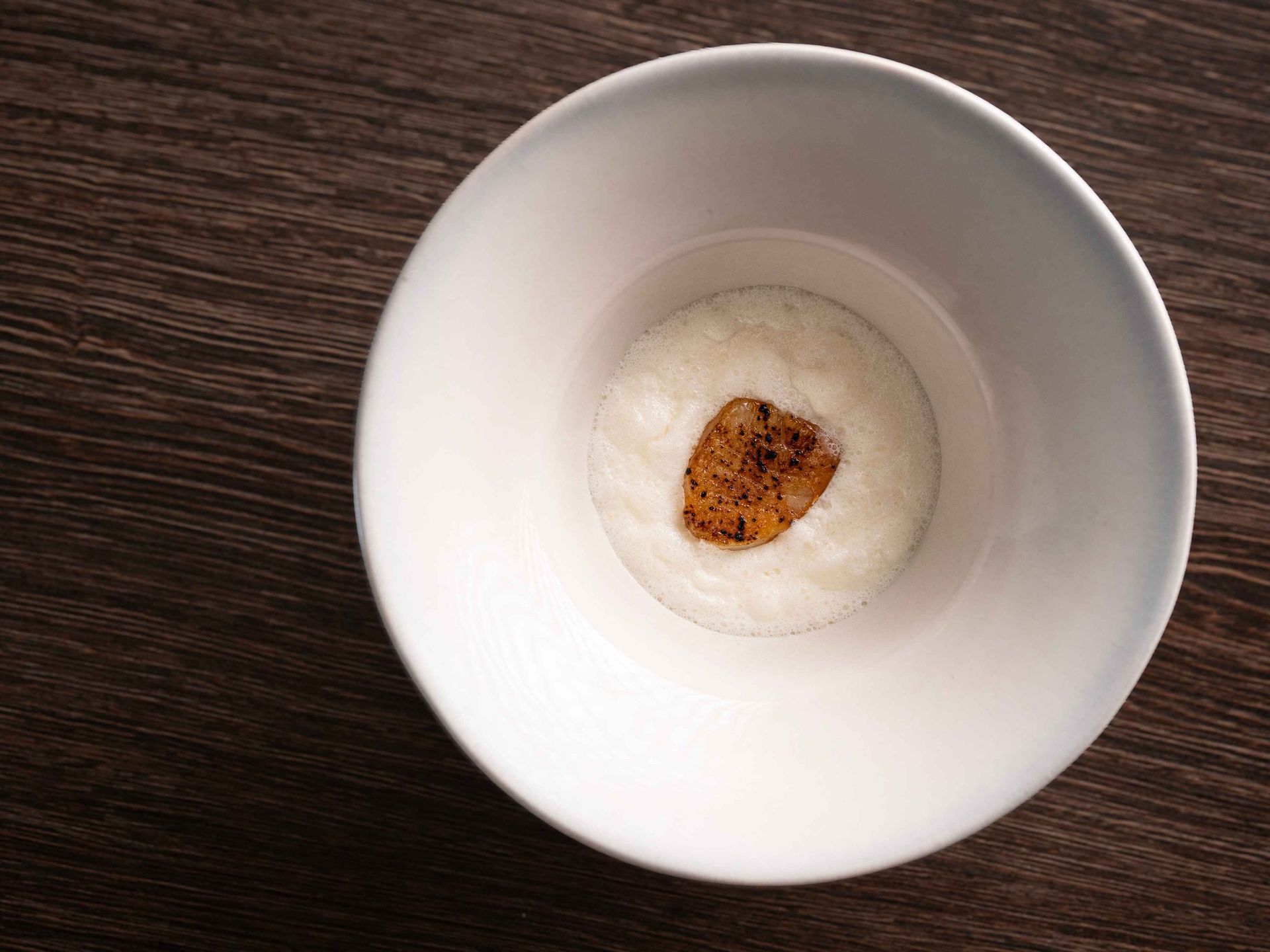 A white bowl with a heart in the middle of it