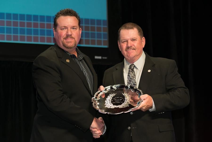 Two Men are Shaking Hands while holding a Trophy | Vallejo, CA | Tri-City Fence Company