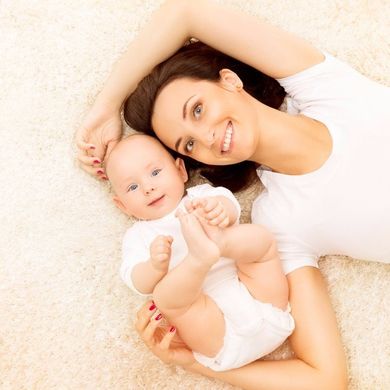 Rug cleaning - Mother and baby lying in carpet in Carlsbad, CA