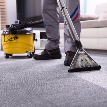 Cleaning - Person Cleaning Carpet With Vacuum Cleaner in Carlsbad, CA