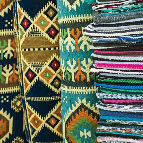 Rug Stack - Colorful background striped pattern of overlocked binding on carpets in Carlsbad, CA