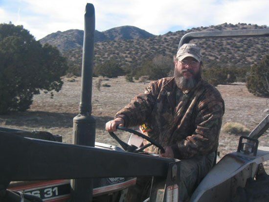 A man is driving a tractor with the number 31 on the side