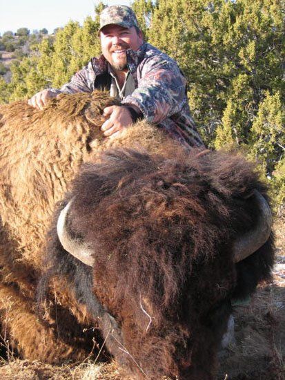 A man is standing next to a large bison, LaMont Buffalo Hunting, Bison Hunt.