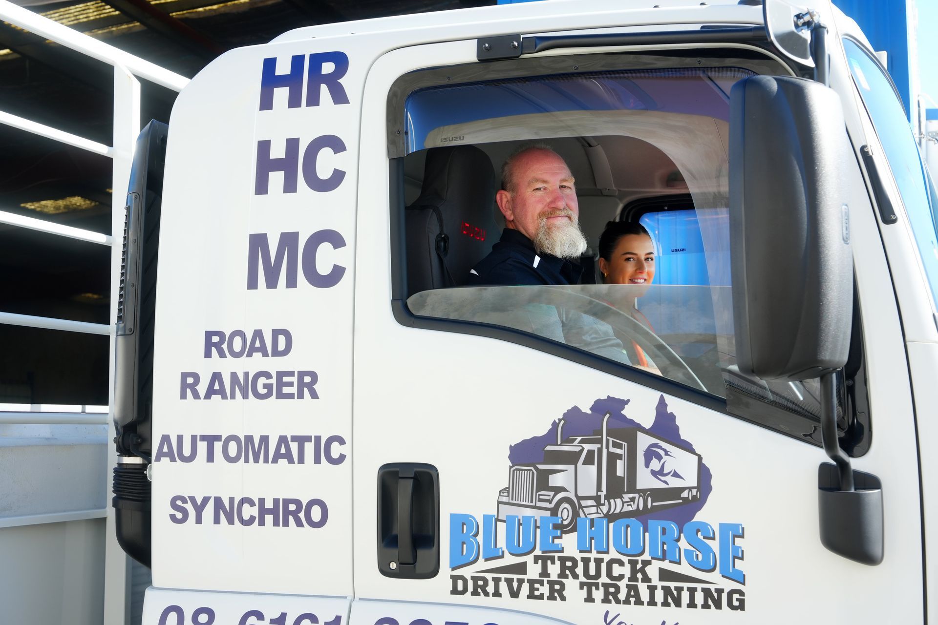 Man and woman in truck cab, logo 