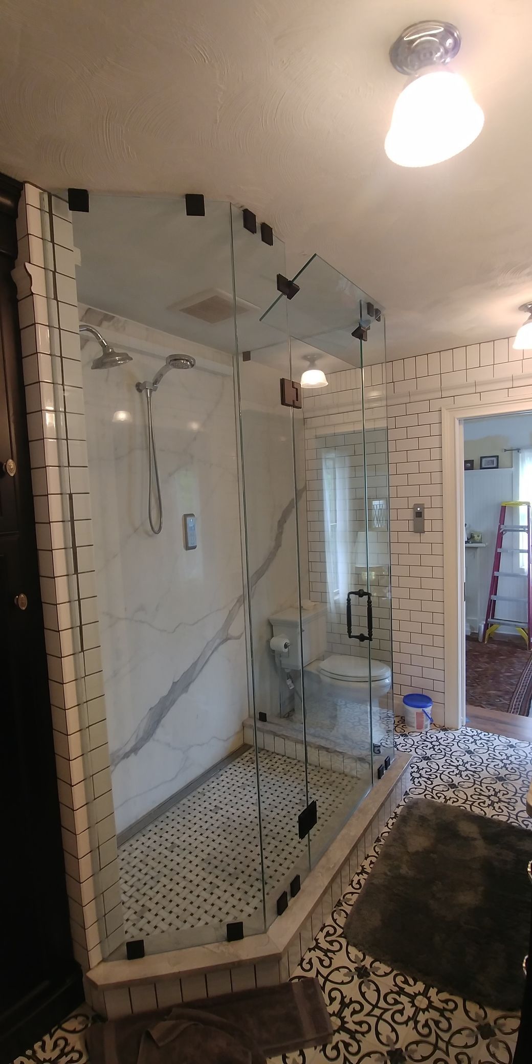 A bathroom with a walk in shower and a toilet.