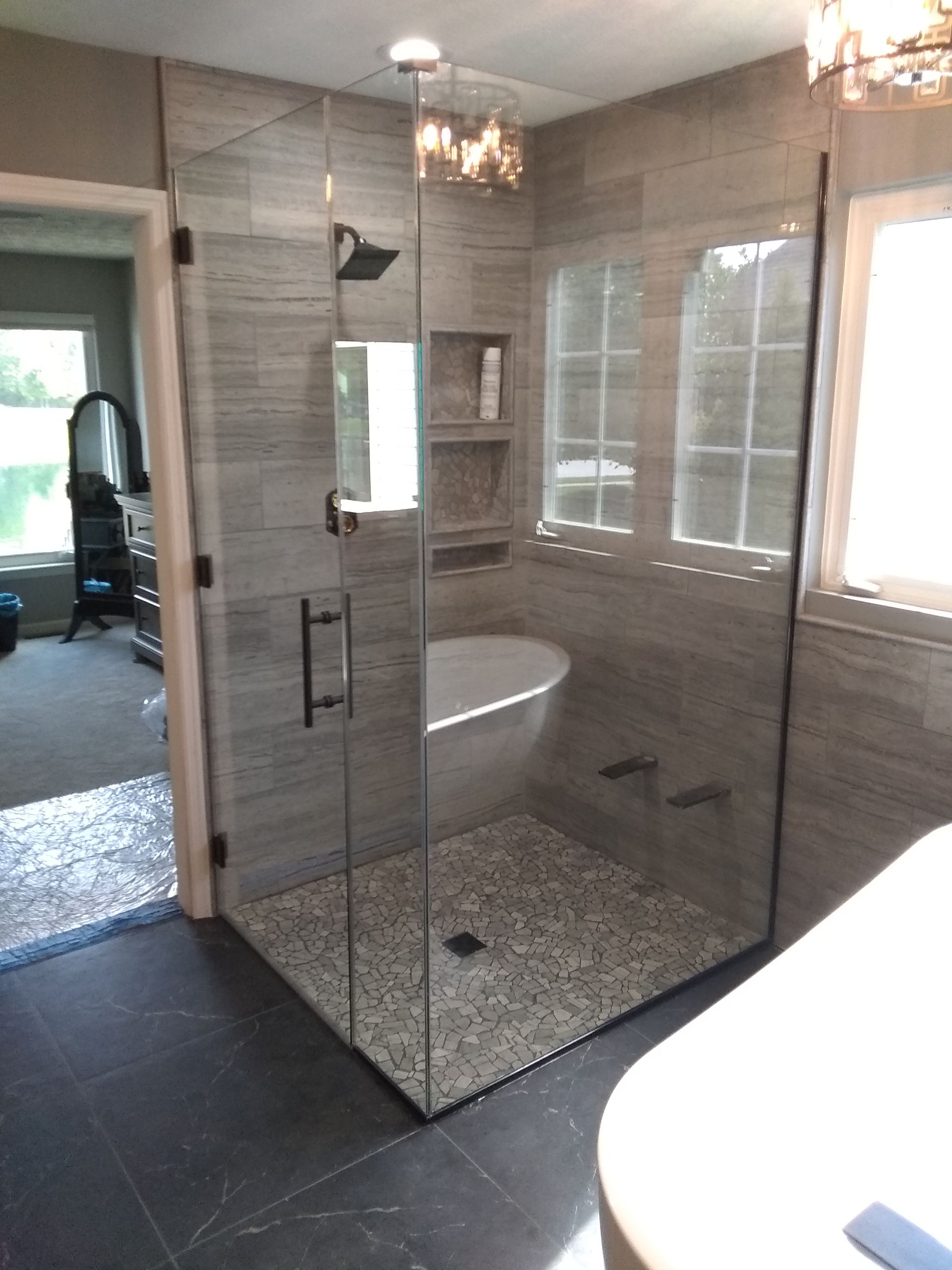 A bathroom with a bathtub and a walk in shower.