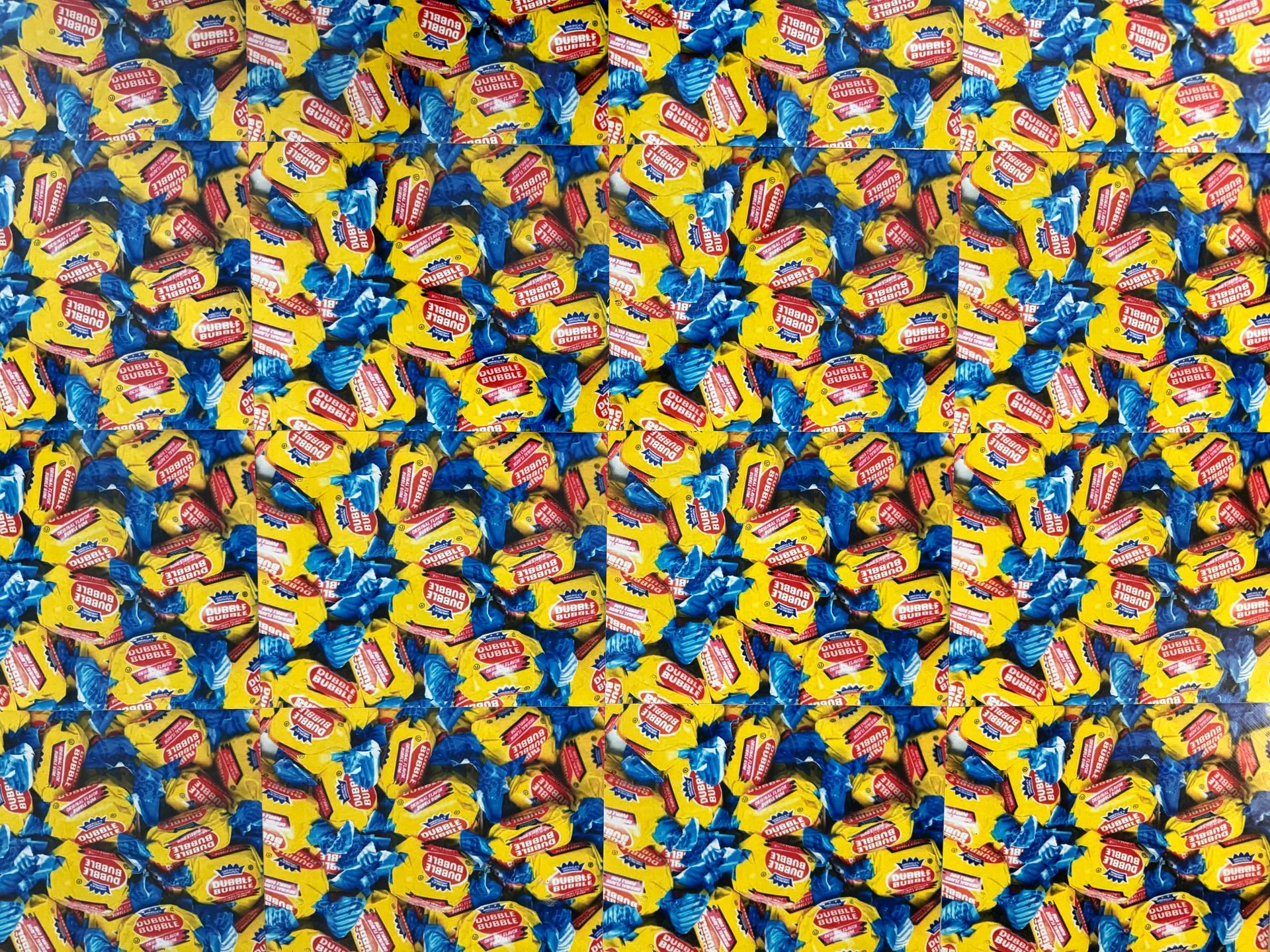 A bunch of yellow and blue candy wrappers are stacked on top of each other.