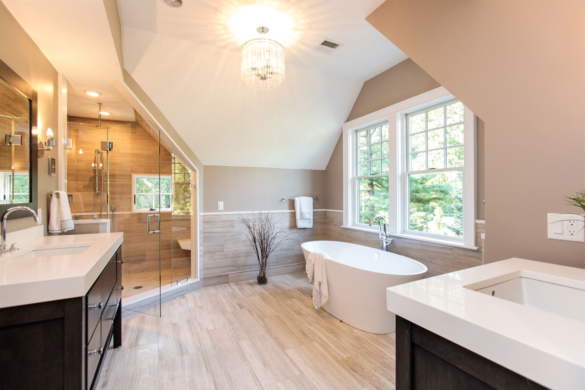 A bathroom with a tub , sink , mirror and shower.