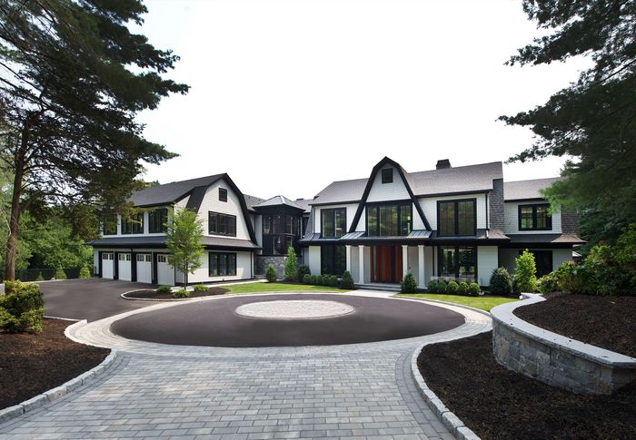 A large house with a circular driveway in front of it