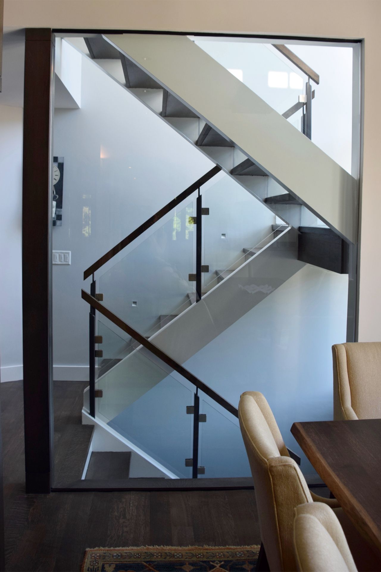 A staircase in a house with a glass railing