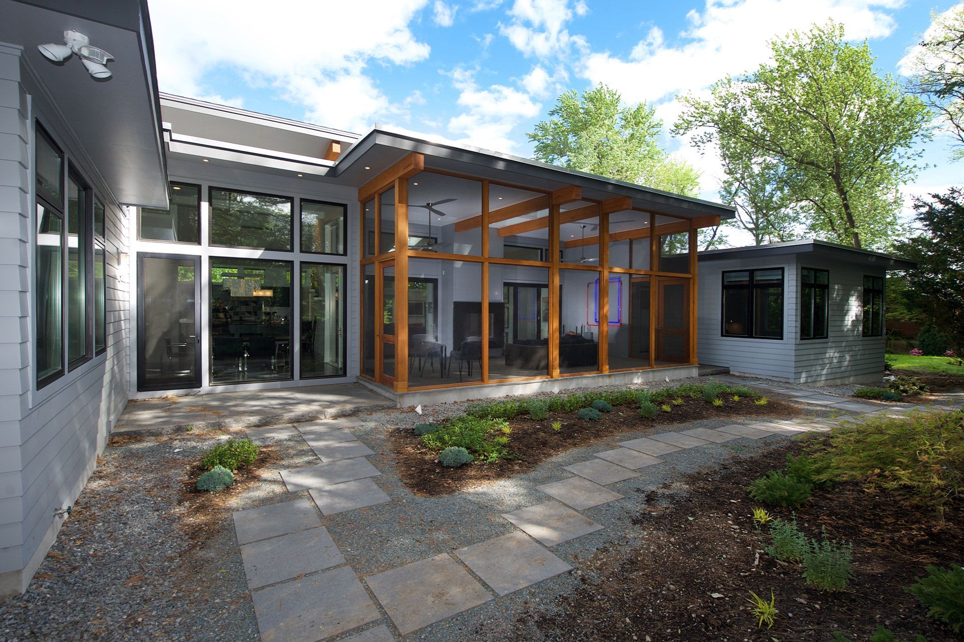 A house with a lot of windows and a walkway leading to it