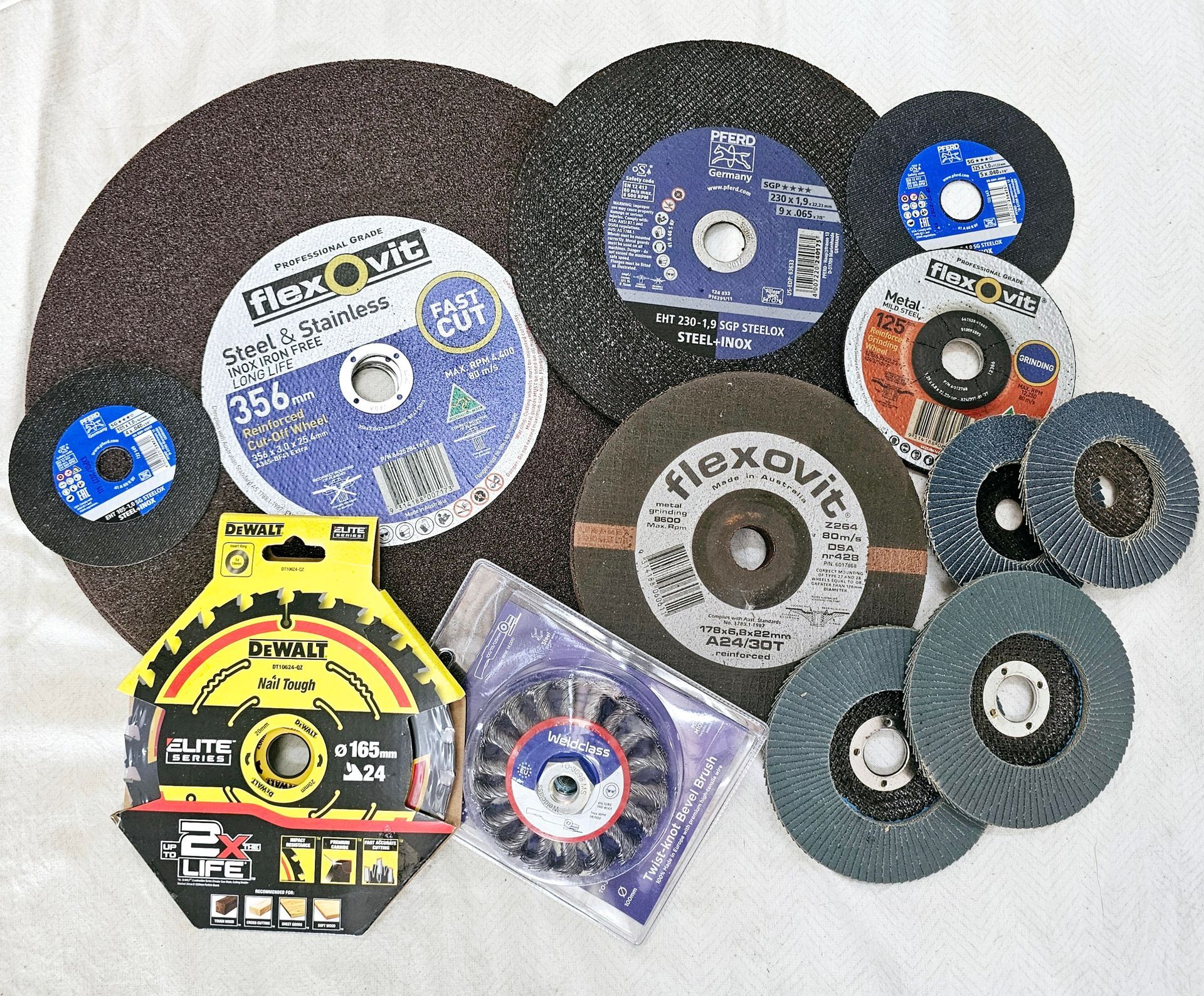 A bunch of different types of grinding wheels on a table