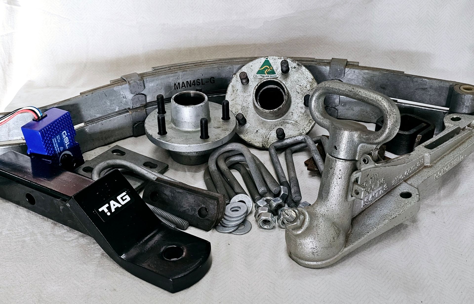 A bunch of metal parts with tag written on one of them