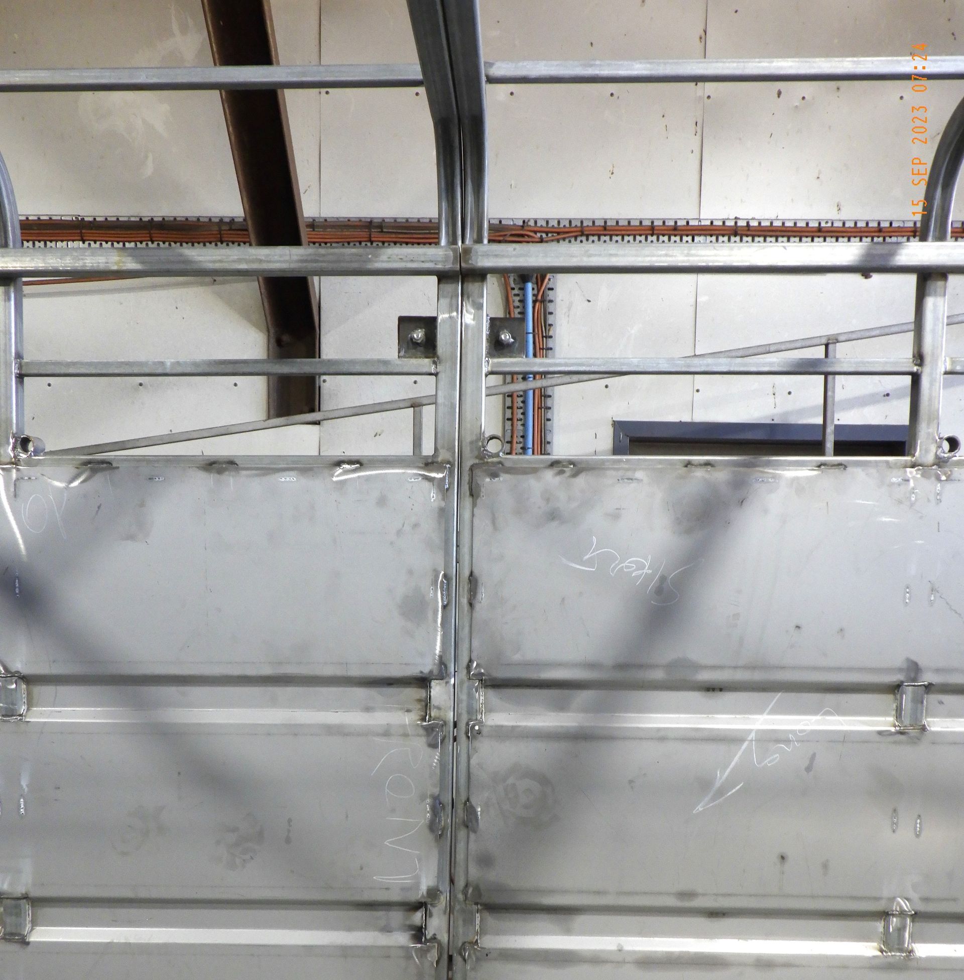 A garage door with a metal railing on it
