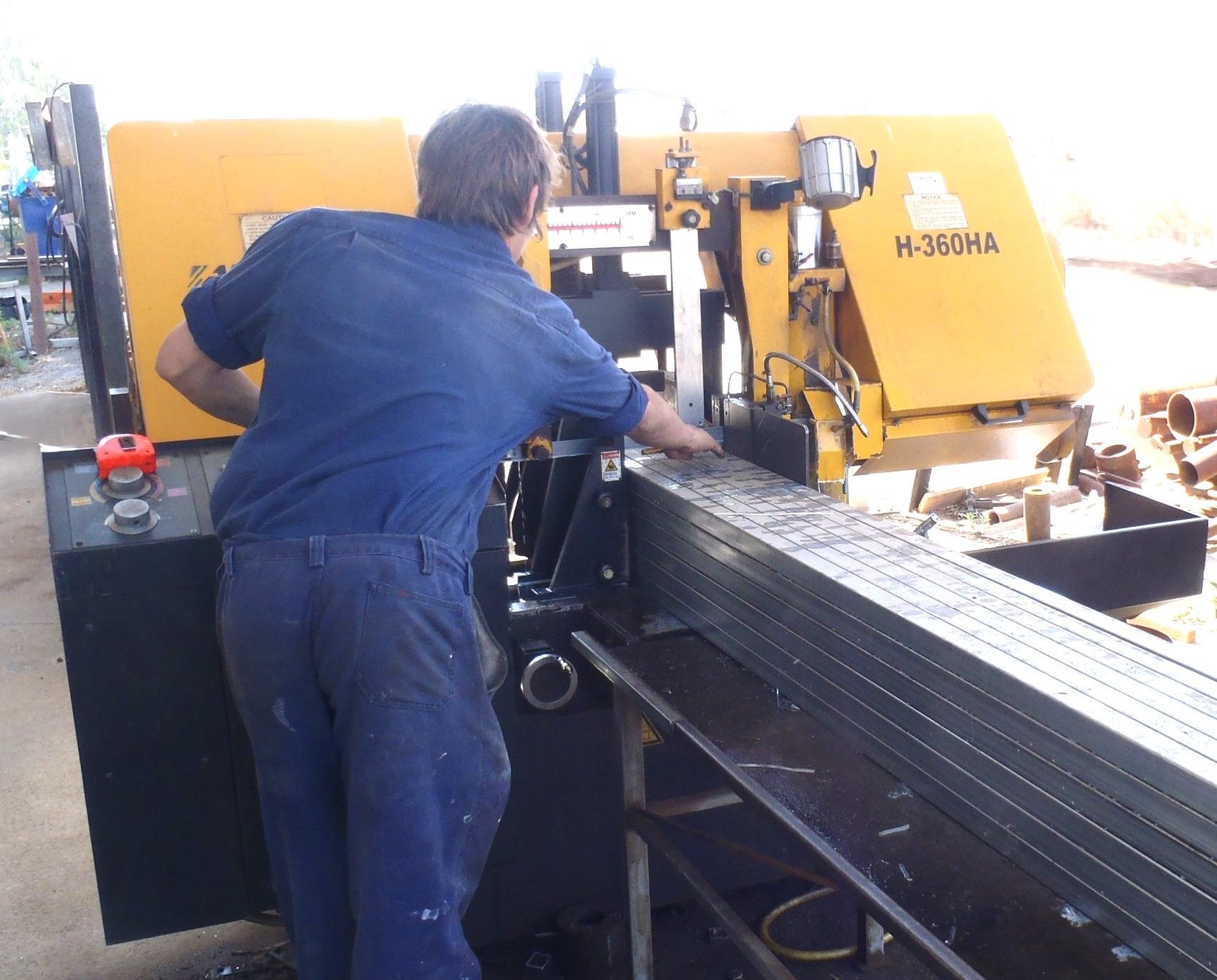 A man is working on a machine that says h-360ma