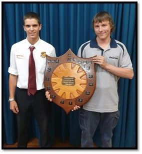 Two men are standing next to each other holding a wooden shield.