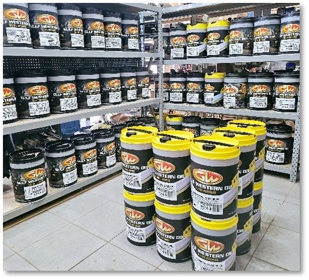 A warehouse filled with lots of buckets of oil.