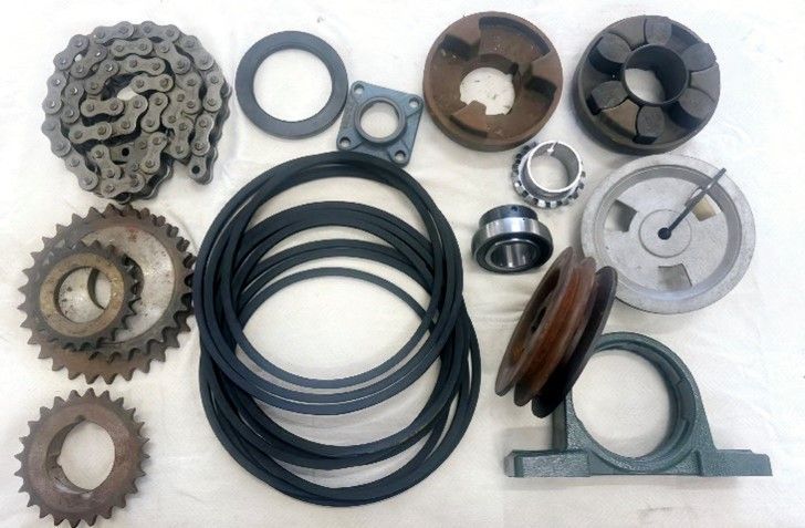 A bunch of gears and belts on a white surface